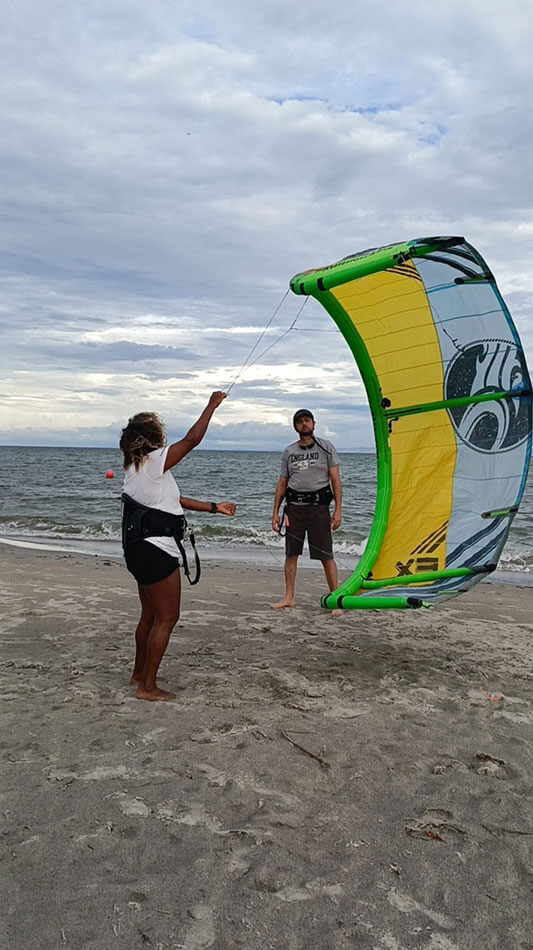 A Mar&Luna instructor teaching a student how to manage the kite