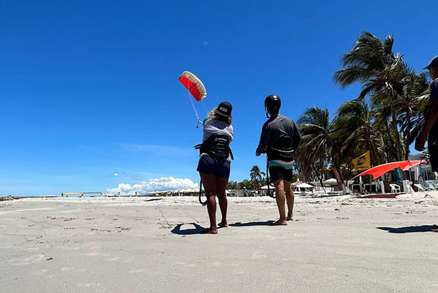 Instructor teaching a student the mechanics behind the kite and the wind