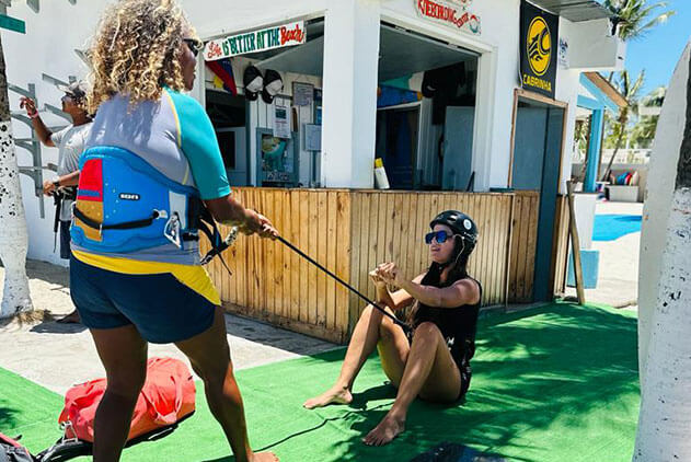 Instructor teaching a student to pull the kite